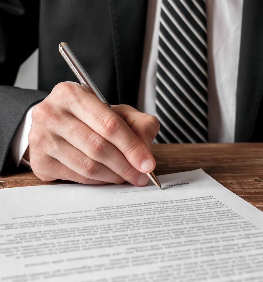 Businessman signing a document.